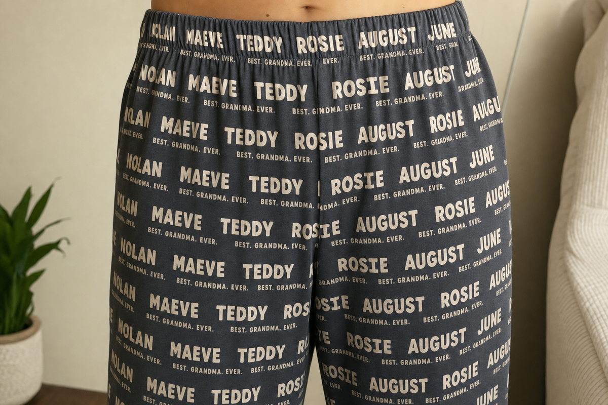 The gathered elastic waistband of custom pajama pants printed with grandchildren's names, worn