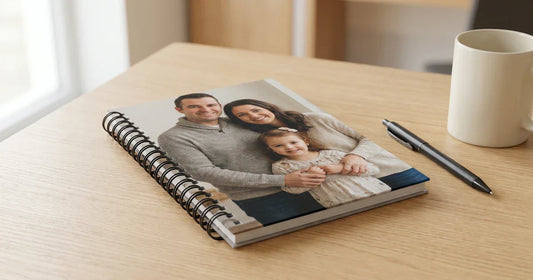 Premium custom spiral notebook with a personalized photo front cover and black metal spiral binding, styled on a clean desk in soft natural light for a practical gift-worthy Custom Envy blog hero.