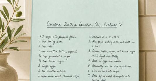 Handwritten family recipe design displayed on a personalized glass cutting board in a kitchen setting.