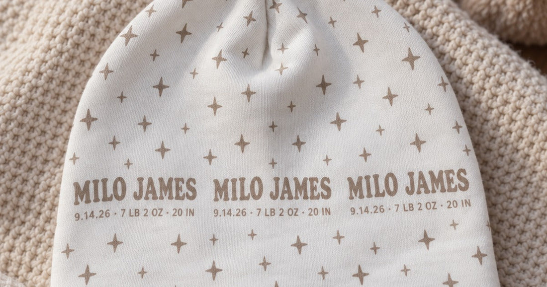 Custom baby beanie printed with a repeated name, birth details, and star pattern.