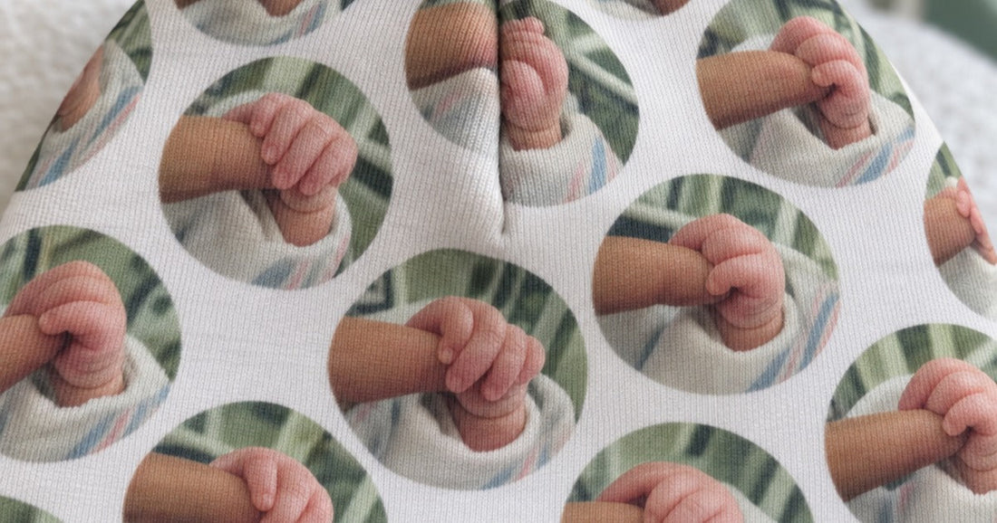 Close view of an all-over custom baby beanie design near the printed seam.