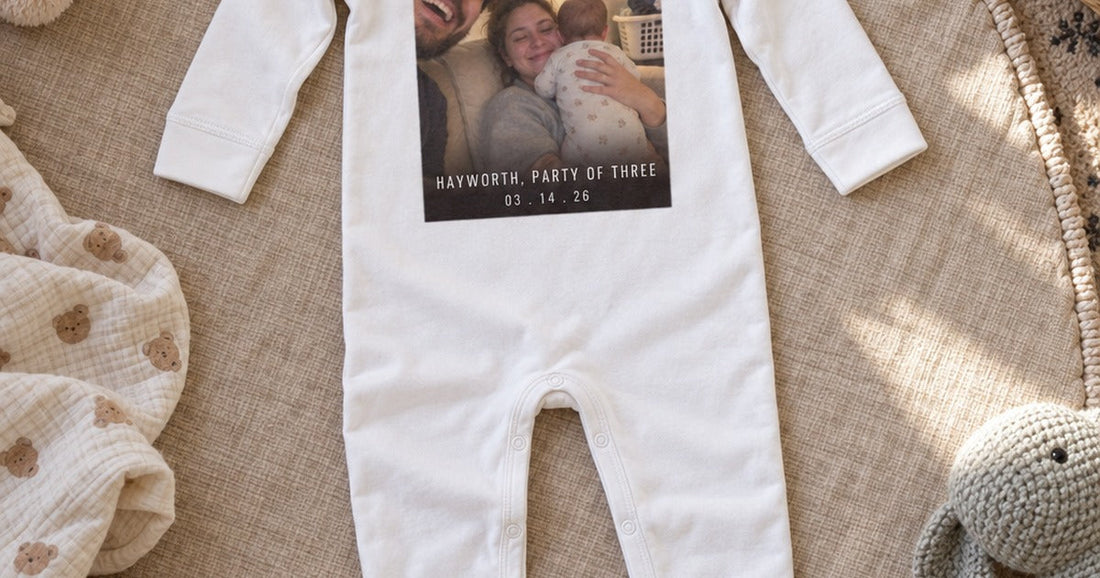 White long-legged baby bodysuit shown flat with a personalized family photo across the front.
