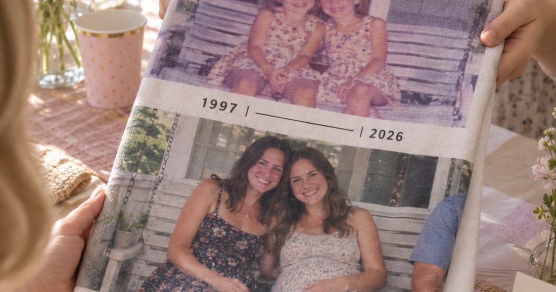 Person holding a folded personalized baby swaddle blanket printed with family photos and the years 1997 and 2026.