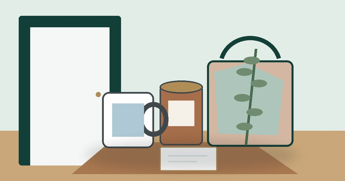 Neighbor gift ideas with a custom ceramic mug, personalized candle, tote, small card, and greenery by a front door.