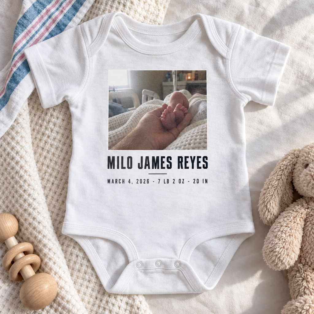 Custom Baby Bodysuit printed with a personalized design, laid out in a warm nursery scene
