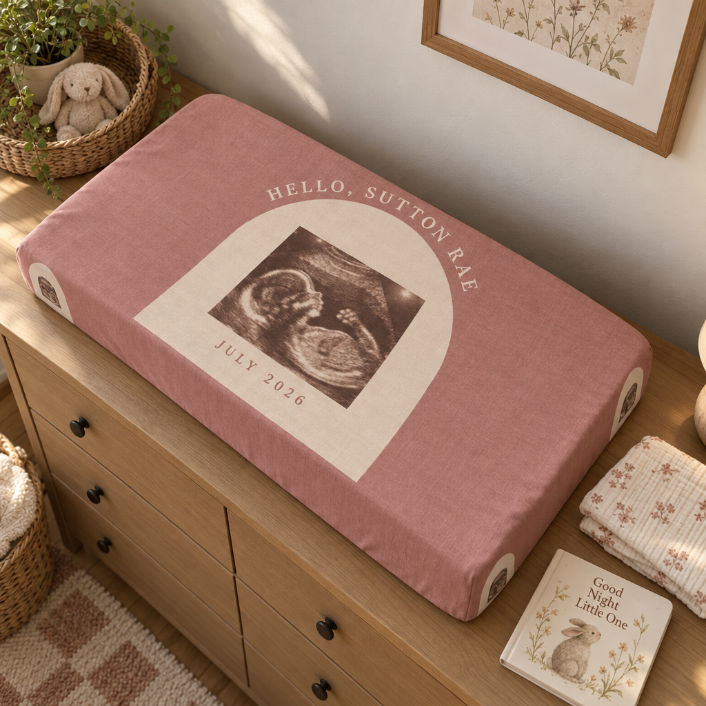 A custom changing pad cover laid flat showing the full printed surface