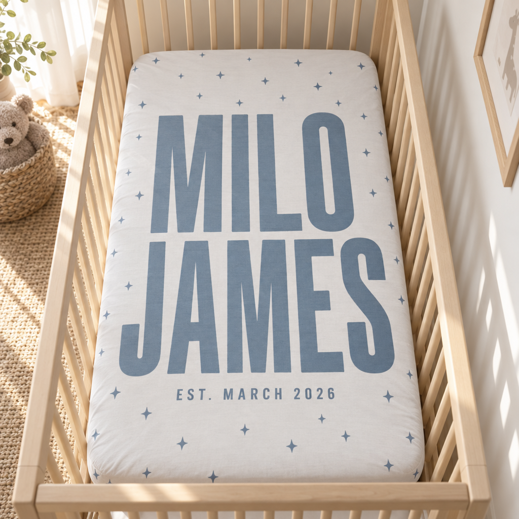 Custom Fitted Crib Sheet personalized with a photo and name, laid out in a warm nursery scene (01-hero.png)