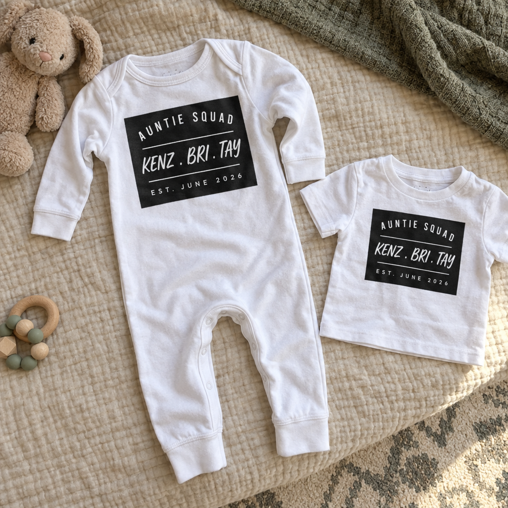 A black and a white long-legged baby bodysuit side by side carrying the same printed design
