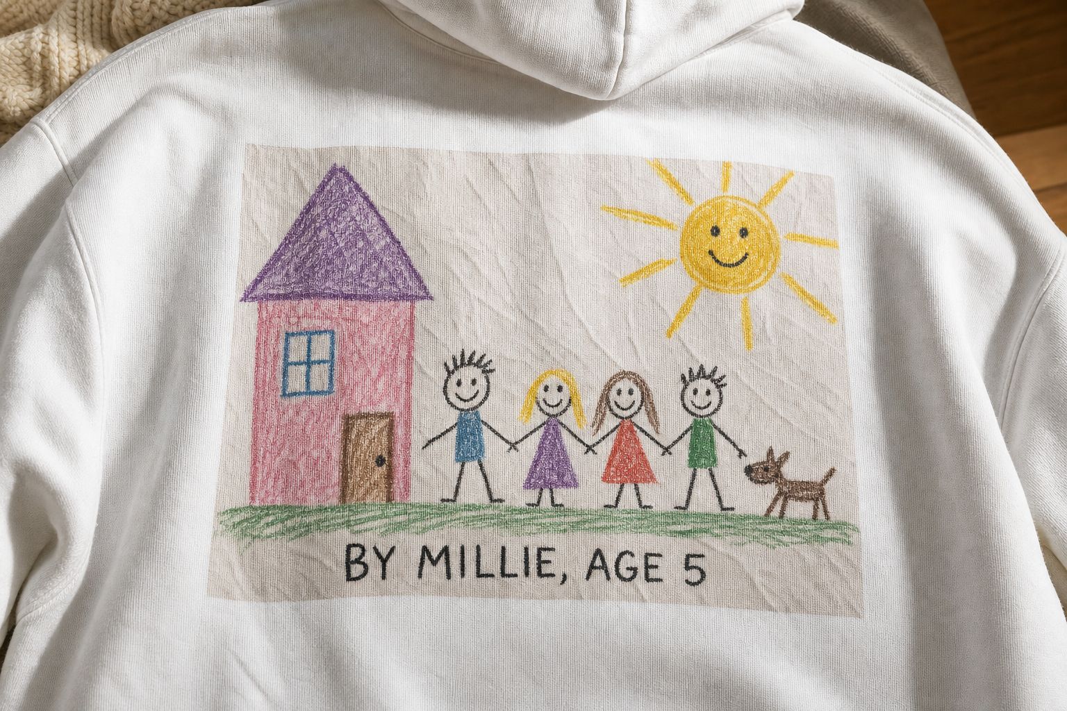 Close view of a child's crayon family drawing printed into the fleece knit of a white custom hoodie