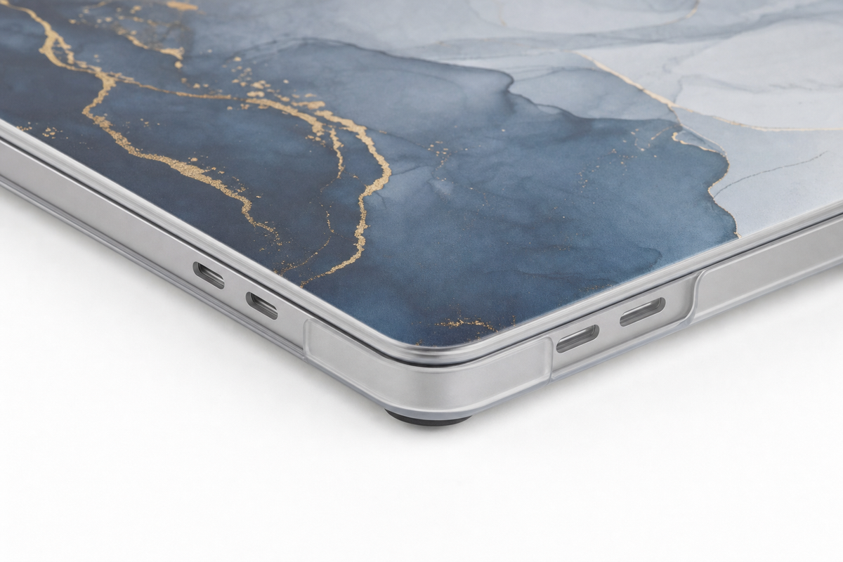 Close view of a corner of the custom MacBook case showing the thin shell wrapping the laptop edge
