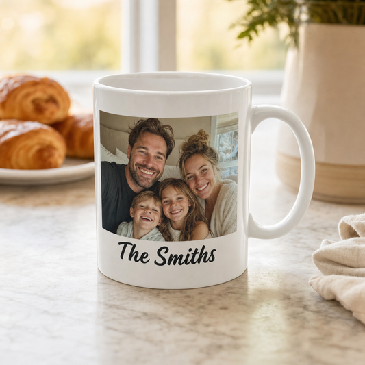 Custom white ceramic mug with a family photo and the name The Smiths, C-handle visible