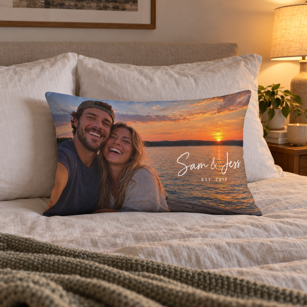 Custom lumbar pillow printed with a couple's sunset selfie and Sam and Jess on a made bed