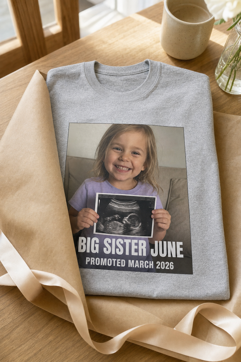 A folded custom photo t-shirt half-wrapped in birthday paper with a ribbon