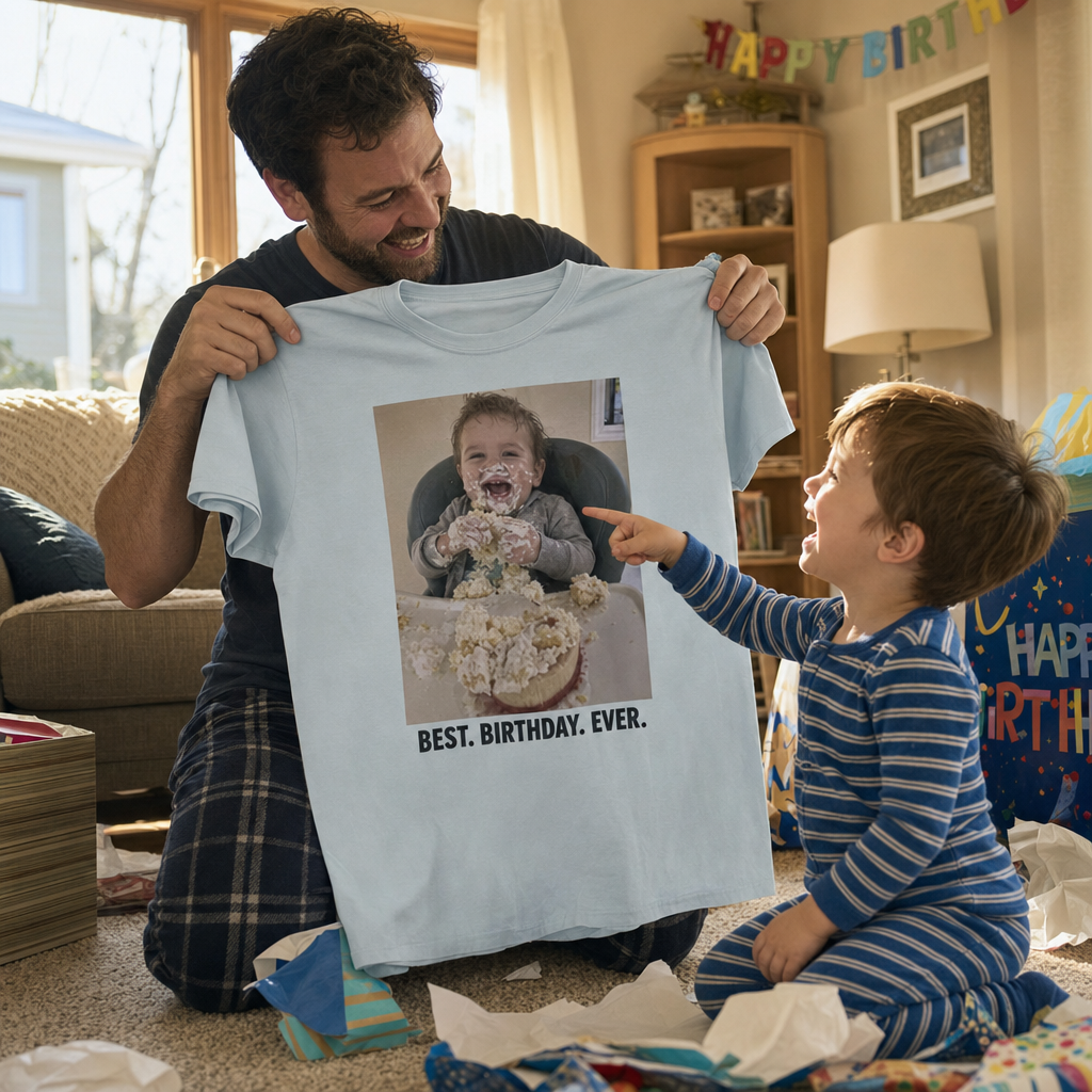 A dad holding up a custom birthday photo t-shirt while the birthday kid laughs