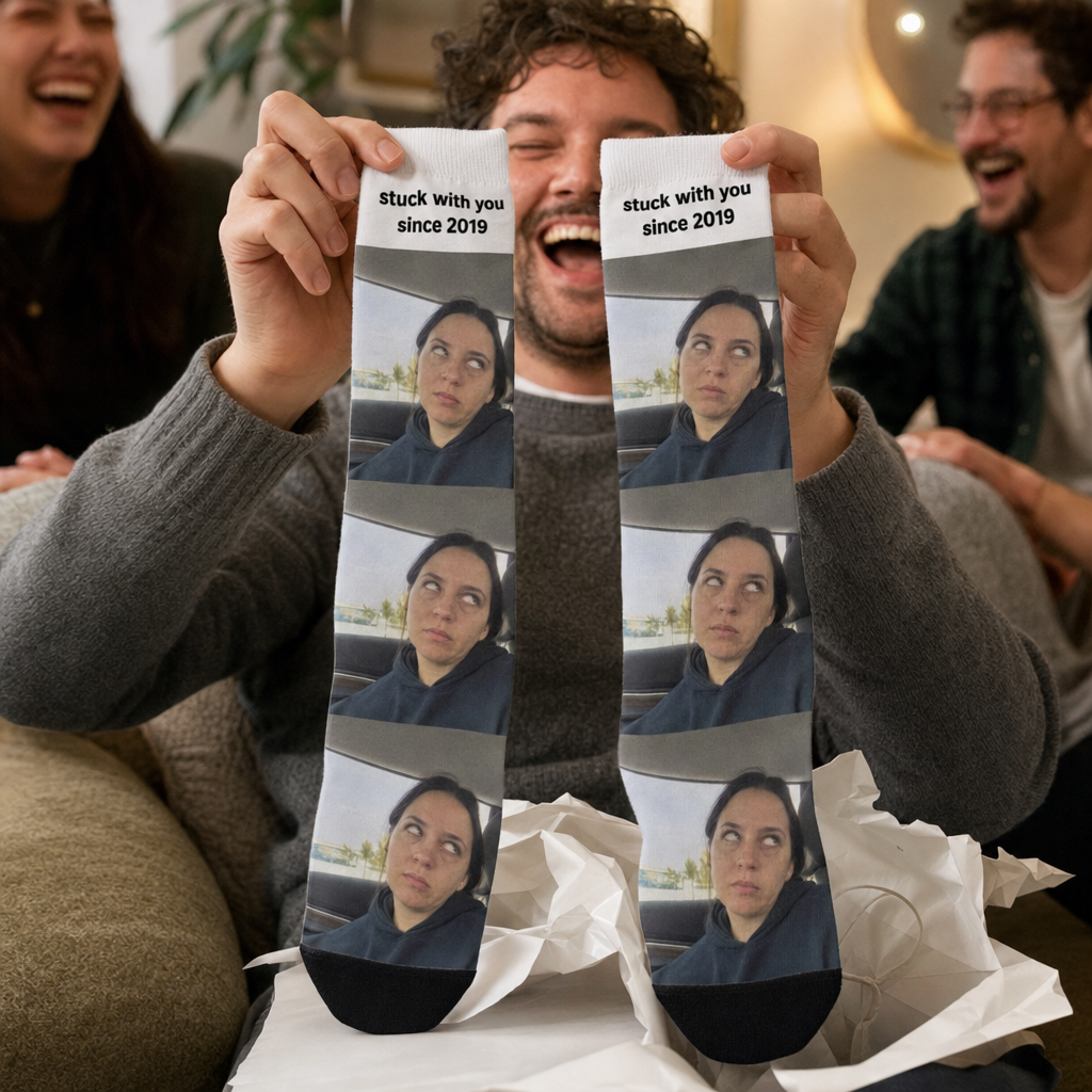 A man laughing while holding up custom photo socks printed with a tiled candid photo and cuff text