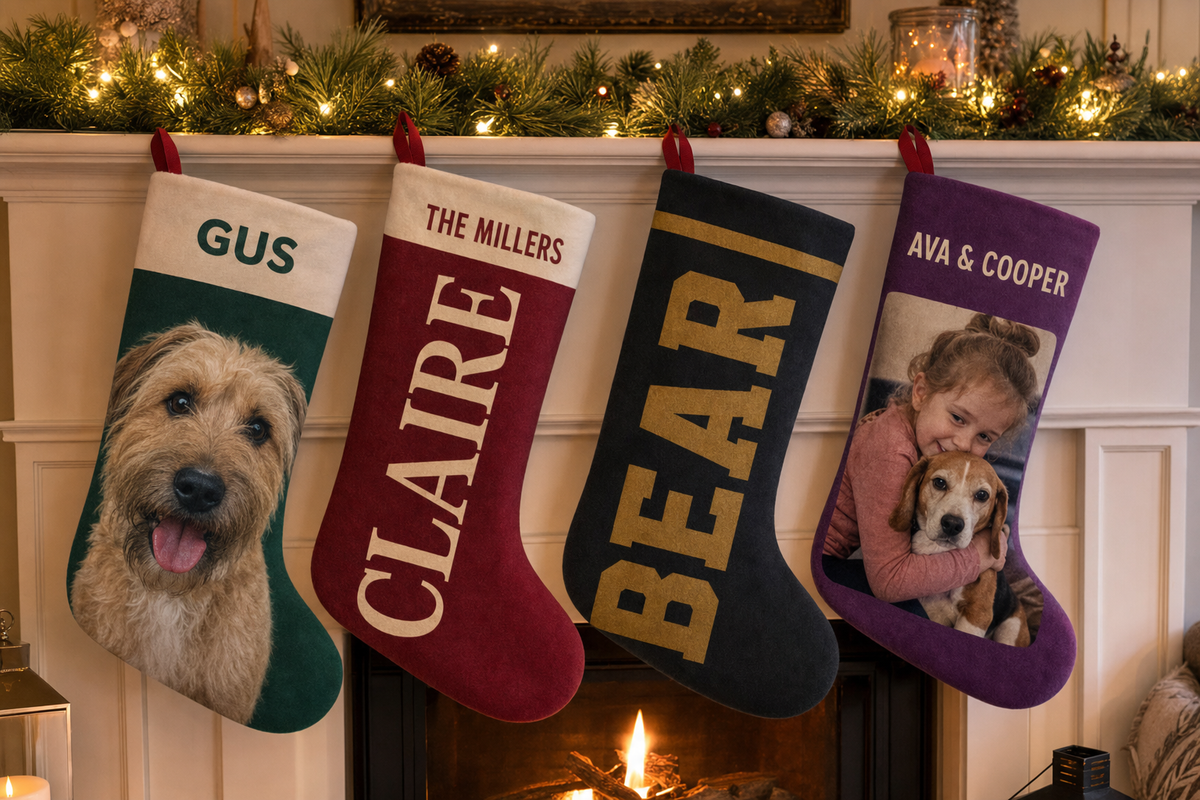 Four coordinated personalized stockings hanging from one mantel, each with a different family member's design including the dog