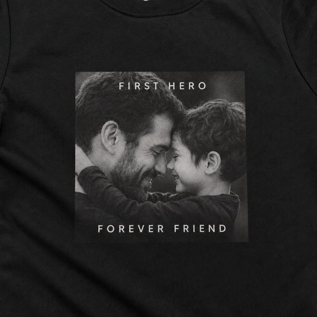Close-up of a black-and-white father-and-son photo print reading FIRST HERO FOREVER FRIEND on a custom toddler tee