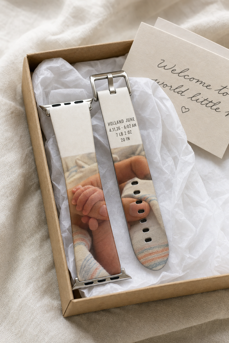 A custom photo Apple Watch band coiled in an open gift box with tissue paper