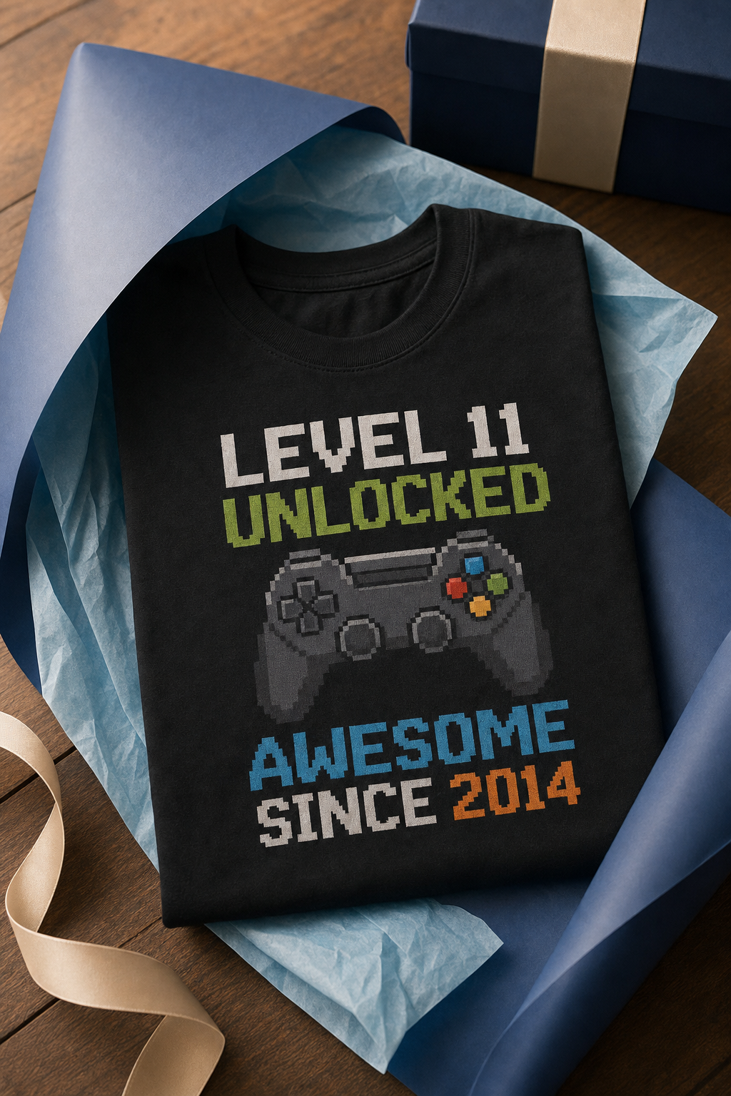 Youth tee printed with a pixel-art LEVEL 11 UNLOCKED birthday design, half wrapped in plain blue gift paper