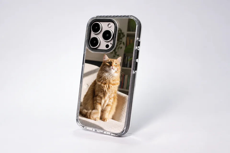 Ultimate + MagSafe case standing upright, printed with a photo of a ginger cat, clear bumper edges