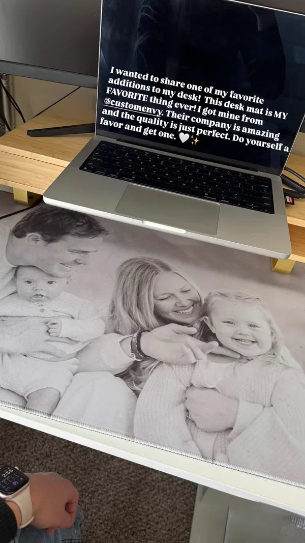 Black and white family portrait desk mat under laptop on standing desk