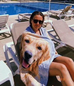 Customer wrapped in custom beach towel poolside