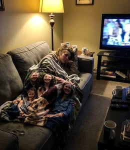 Custom photo blanket with family portrait draped on couch