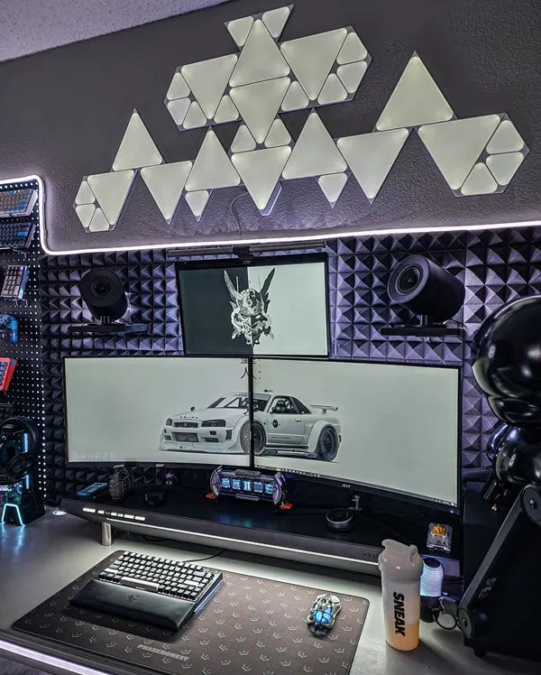 Dark gaming battlestation with custom patterned desk mat and triple monitors