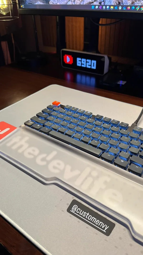 Developer themed desk mat with mechanical keyboard and blue backlighting
