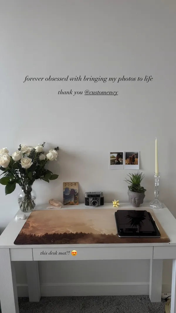 Sunset landscape photo desk mat on white desk with camera and flowers